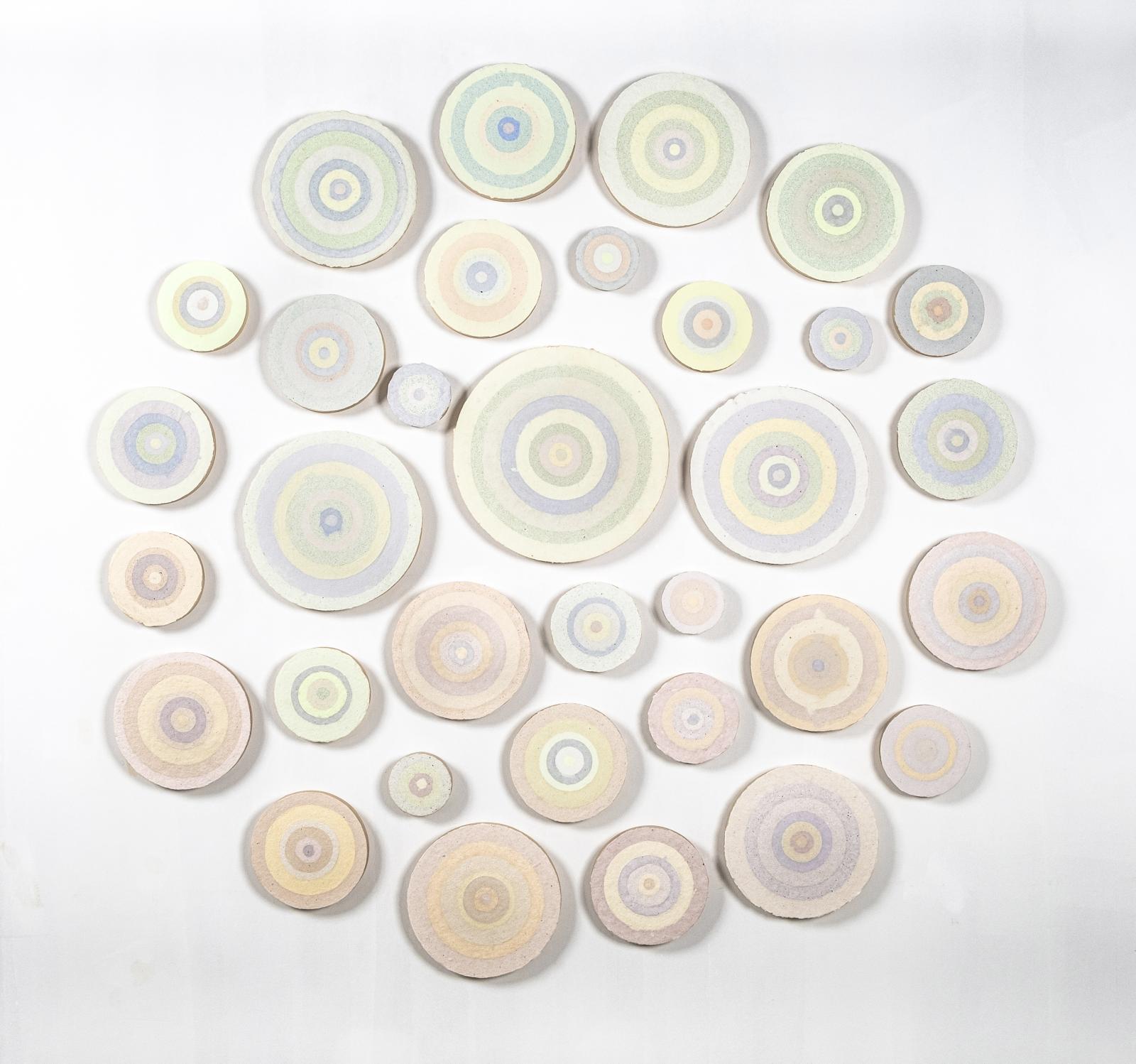 A 33-piece installation of hand-made paper from recycled screenprints on 1" deep plywood rounds of varying circumferences..
