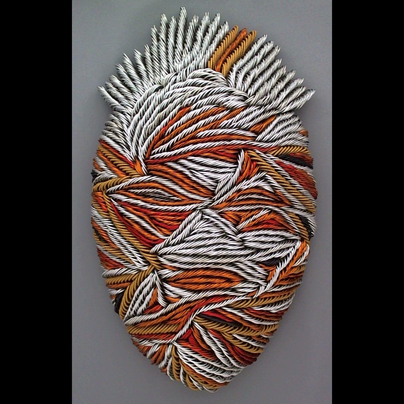 From 500-900 colored wire strands of various lengths and gauges are shaped and twisted into mask sculpture.