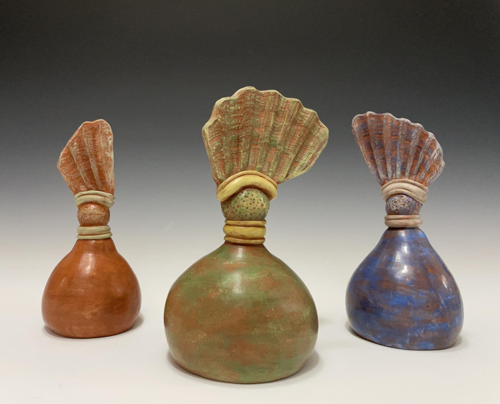 These shell bells were created using bits of shells gathered at Calvert Cliffs in Maryland. Each of the three bells produces a different note based on the size of its bell; the smaller the bell the higher the note and vice versa.