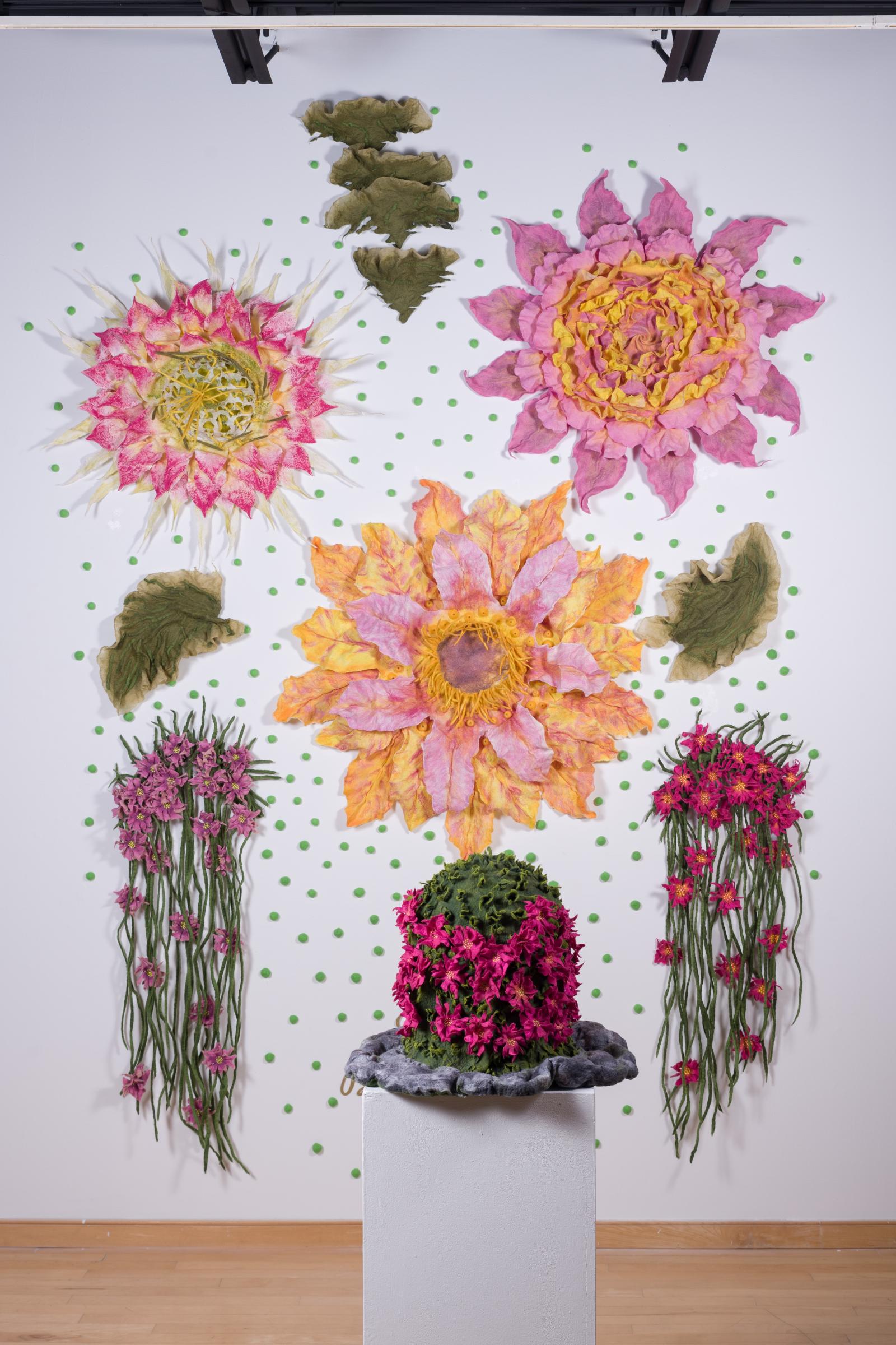 When we creating a composition “Cactus Flowers” consisting of wall sculptures and many small elements, as well as freestanding sculpture, we were inspired by a blooming cactus. The art composition consists of more than 150 elements and each element reflects our creative vision and interpretation.
Each person looking at the composition “Cactus Flowers” will be able to find their own meaning and inspiration, especially in difficult periods of life, this composition helps to survive difficulties by reminding you that despite difficult environmental conditions, cacti are very stable and hardy, while their flowers have an incredible variety and beauty!
The process of creating our sculptures is multi-stage and time-consuming. We worked by hand creating color transitions, shapes, curves from shapeless fibers of natural wool.
The sculptures have a very textured and tactile surface, similar to natural suede.