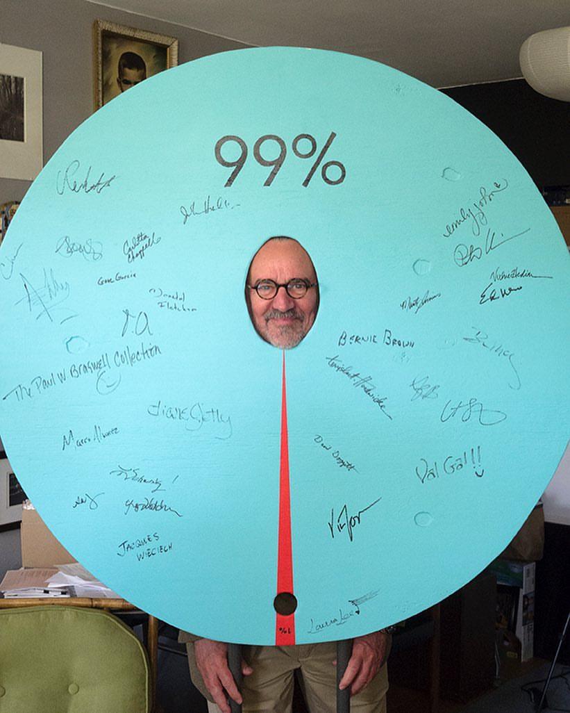 This participatory sculpture is a pie chart representing the income inequality gap in the USA. People can have their photo taken while standing behind it, then sign their name to the front.