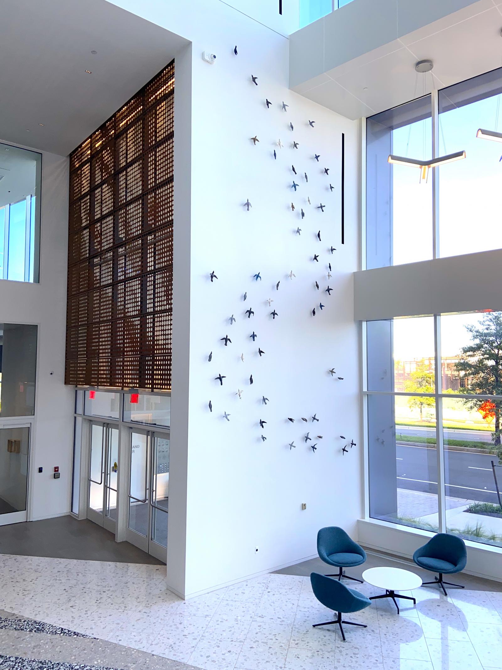 commissioned by the American Physical Therapy Association, I was asked to respond visually in a specified space to their motto: Move to Soar.  The building is their new headquarters in Alexandria, VA.  I used 65 clay birds, in a variety of colored pigments,  in an ascending flight formation spanning a 26'x12' wall space.