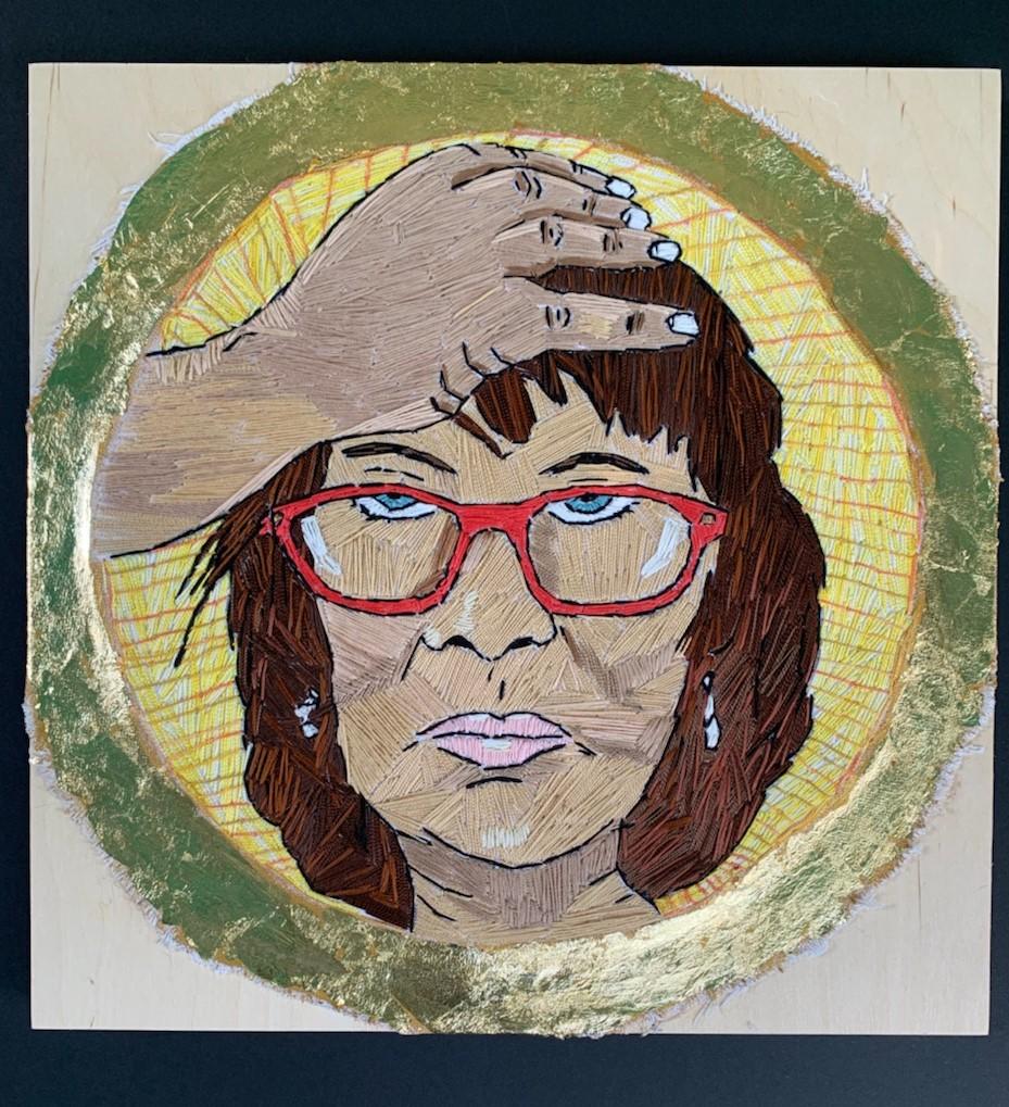 Embroidered self portrait created from a selfie. Mounted on wood with gold leaf.