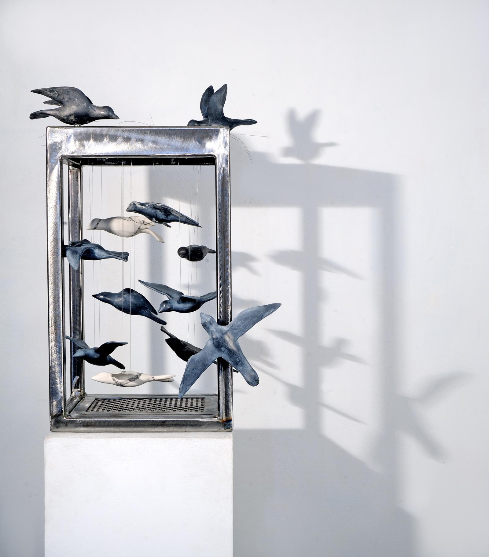 in this piece I used a new material (steel) to showcase the bird forms in flight.   These birds are somewhat contained by the "cage" but with the sides open, there is the possibility of flight.   The dilemma  for the avian world is the climate crisis that restricts their normal patterns of life: migration, feeding and nesting.   We have lost over 3 billion birds since 1970.