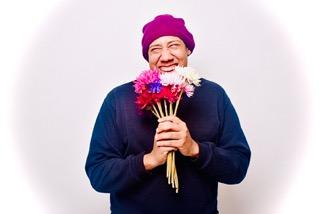 This is one picture from a collection of pictures I took. The title of the collection is called 'Colorful Black Men'. This collection shows a variety of black men with colorful flowers, expressing themselves freely. Some of the pictures are in black and white showing the more subtle solemn side of these beautiful black men. This picture is called 'Flowery Focus', the model's name is Devin.