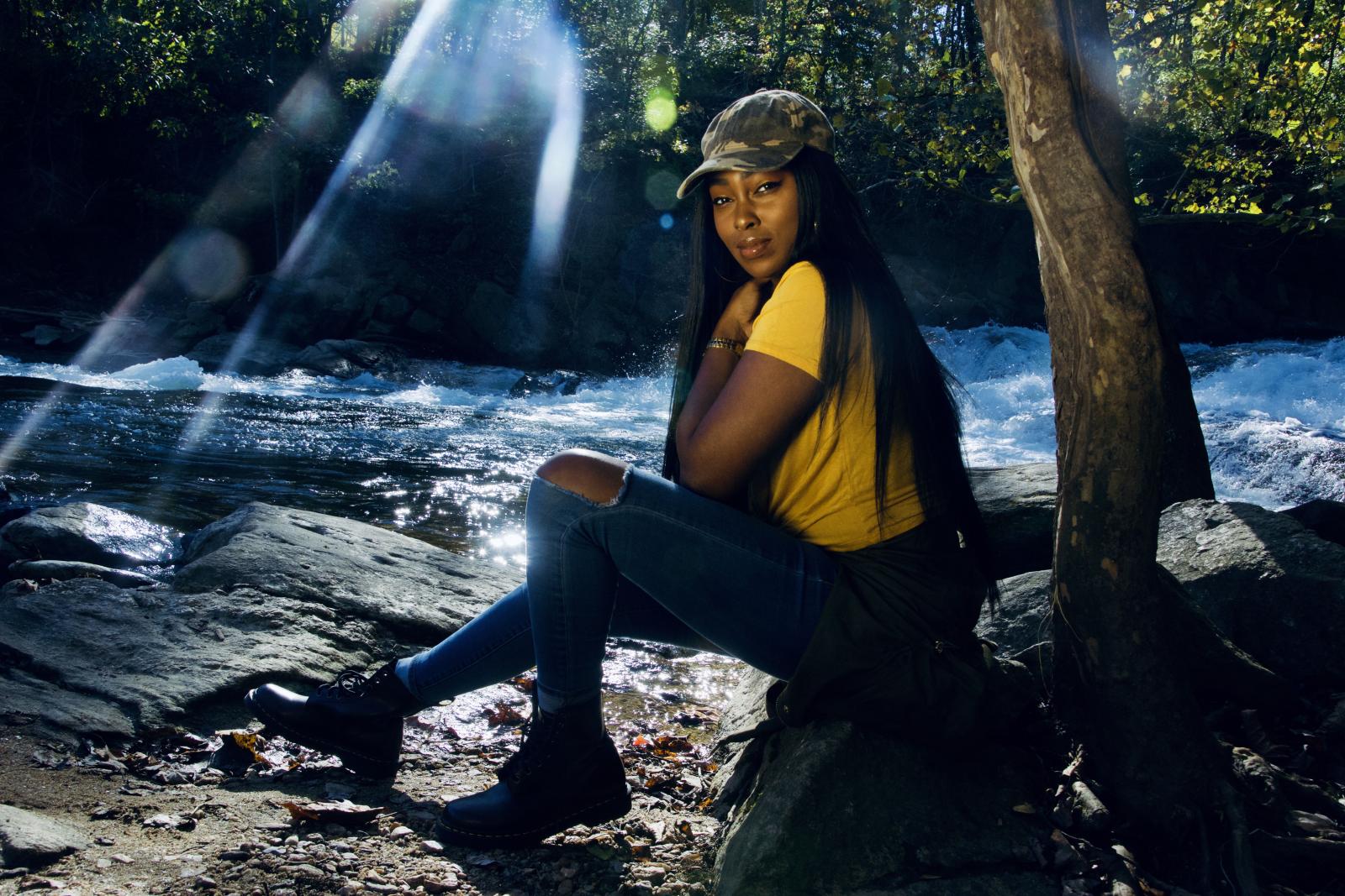 Sunny vibes in the forest with a stream and some leaves.