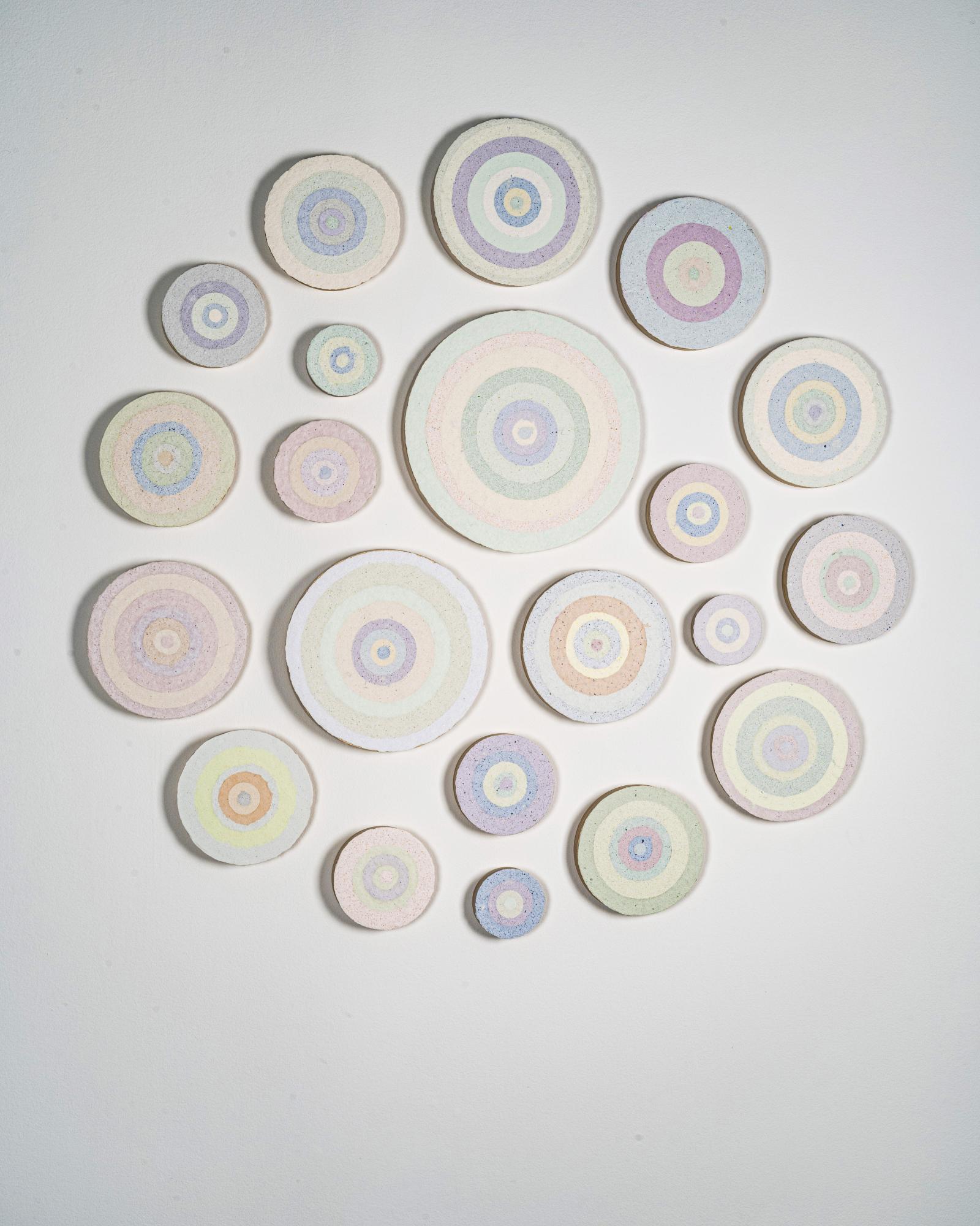 A 20-piece installation of hand made paper cast from recycled screenprints and mounted on plywood rounds of varying circumferences.