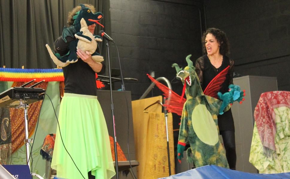 “The Dragon Show; Share, Care, and Play Fair” promotes the social-emotional skills of empathy, respect, self-control, kindness, cooperation and problem solving through the interactive story/drama, Goodbye to a Greedy Dragon.” We’ll explore the Story Elements of character, setting, problem, and solution, use chants and imaginary travel as students become different community helpers, playing rhythms on the tools they each use to help solve the problem.
Assembly Program Pre-K – 4th 50 minutes