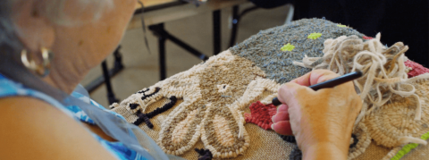 Close-up of hand stitching fiber art