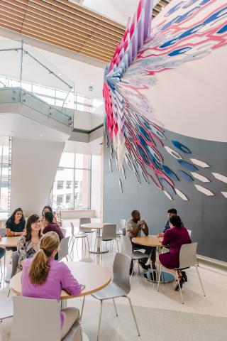 People sitting in front of a mural