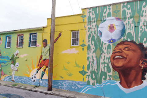 Mural by Rowan Bathurst on side of Soccer Without Borders building in Baltimore City