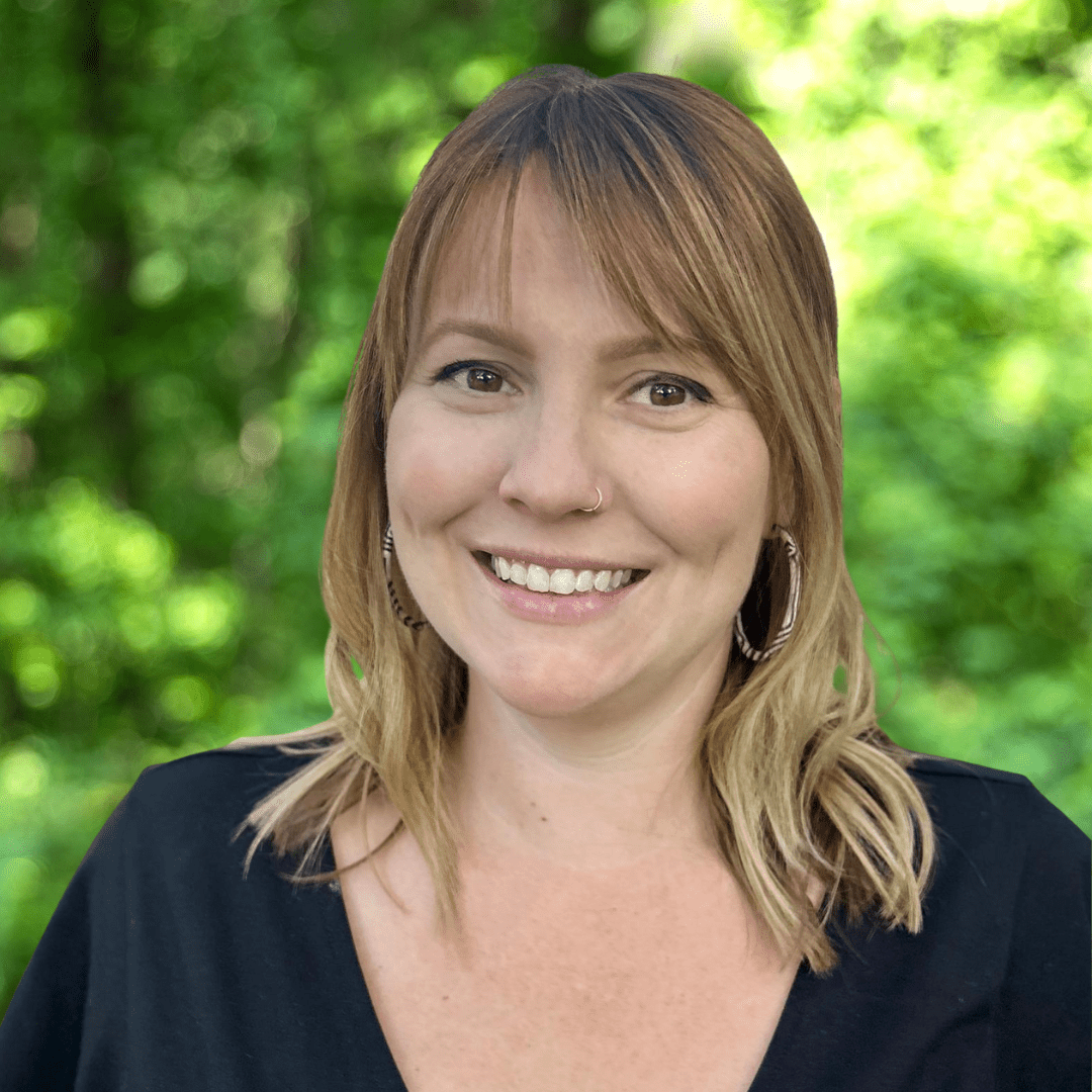 Jess Porter headshot. Woman with shoulder length hair and dark shirt, smiling.