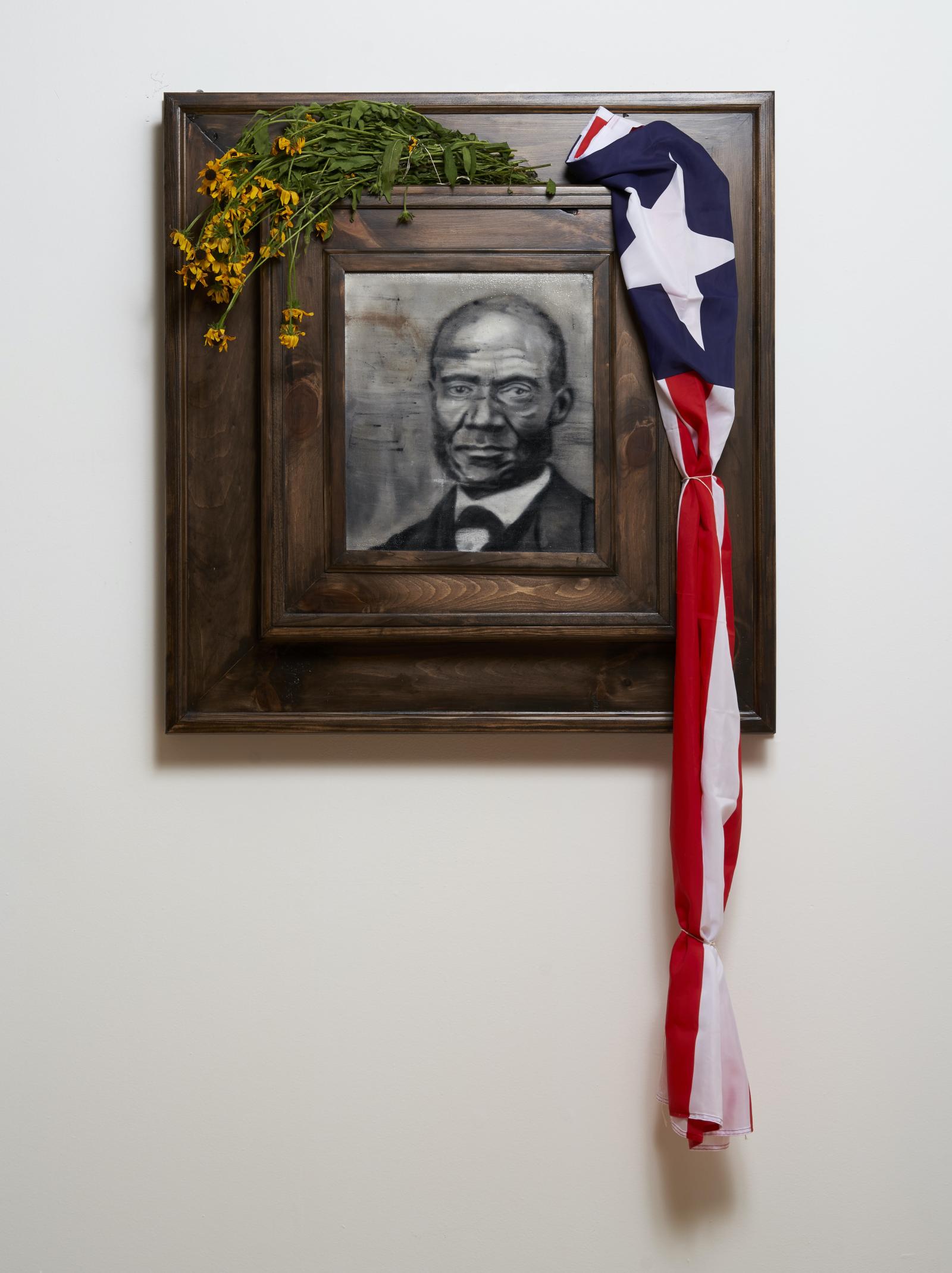 Henry Highland Garnet Elementary School on Calvert Street in Chestertown was the elementary through high school for African American students in Kent County prior to integration. The school’s namesake, Henry Highland Garnet, was born a slave in Kent County, Maryland on December 23, 1815. Nine years later, Garnet was carried north by his parents to freedom in New York where he pursued an education. At the National Negro Convention held in Buffalo, NY in 1843, the then 27-year-old Presbyterian minister rattled the abolition establishment by sponsoring armed insurrection and underscoring the sentiment that the exploited Black people across the continent should “rather die freemen, than live to be slaves.”

By mid-century, Garnet became the founding president of the American and Foreign Anti-Slavery Society, an organization that waged international campaigns against human trafficking. During his tenure, Garnet traveled to the United Kingdom where he spoke widely against the practice of slavery. His collaborations throughout the Caribbean, Mexico, and South America expanded the meaning of emancipation.

Garnet was also a controversial proponent of Black immigration to other countries, such as Liberia in Africa. During the Civil War, Garnet recruited black soldiers to the Union Army, barely escaping a vengeful white mob during the New York Draft Riots of 1863. In 1865, Garnet made history when selected by President Lincoln as the first African American to deliver a sermon to the U.S. Congress after the passing of the 13th Amendment that gave African American men the right to vote.

In 1881, President James A. Garfield appointed Garnet to serve as U.S. Minister and Counsel General to Liberia (United States ambassador to Liberia), fulfilling his lifelong dream to travel to Africa. However, Garnet died on February 13, 1882, only a few months after his arrival. He was given a state funeral by the Liberian government.

Accompanying this framed portrait of Garnet, the Black Eyed Susans, Maryland’s state flower, represents Garnet’s birthplace and the Liberian flag represents his resting place.