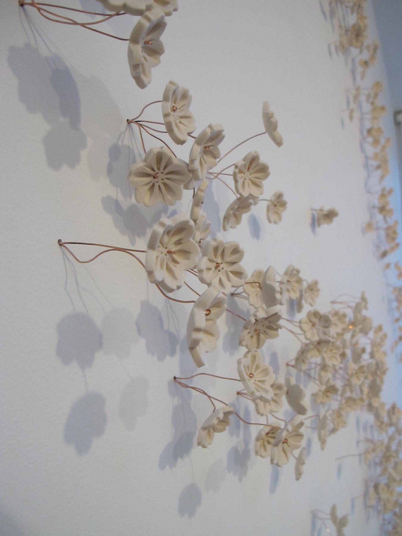 Porcelain cherry blossoms symbolizing the 3,020 cherry trees given to Washington, DC by Tokyo, Japan in 1912. Installation sizes have varied from the full 3,020 to as few as 50, installed to suit the venue.