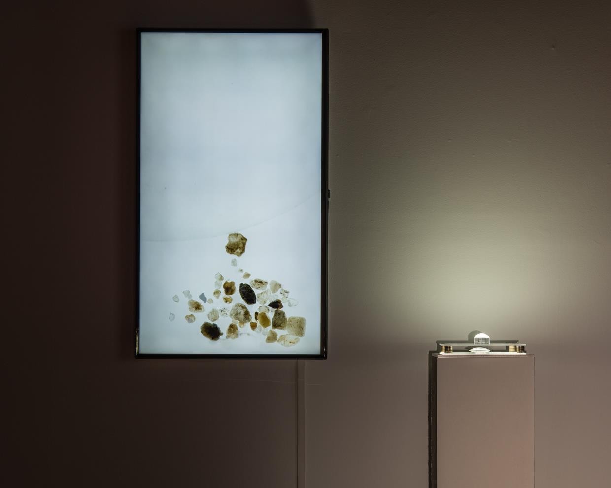 10 second video loop of grains of sand pushing through an invisible barrier.