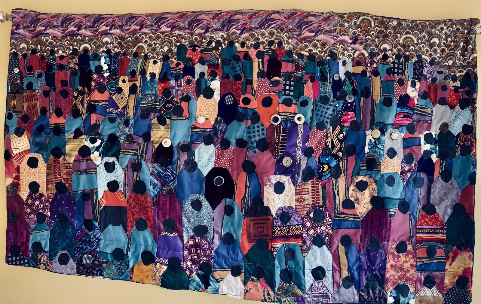 Single-block pieced quilt with raw edge applique. African and other ethnic fabrics, western and recycled fabrics, acrylic paint, buttons