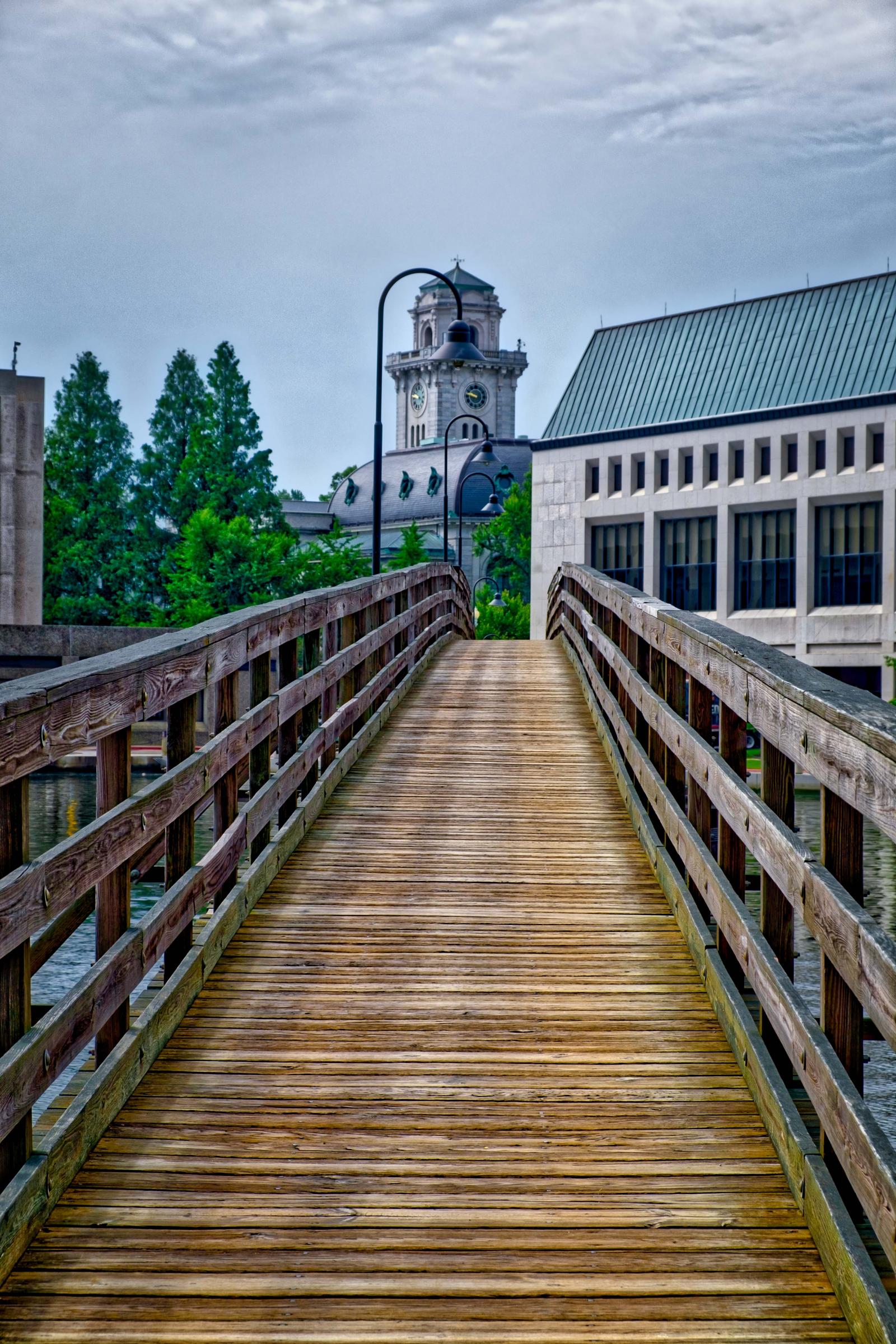 Image of the foot bridge on the Naval Academy with Mahan Hall in the background.