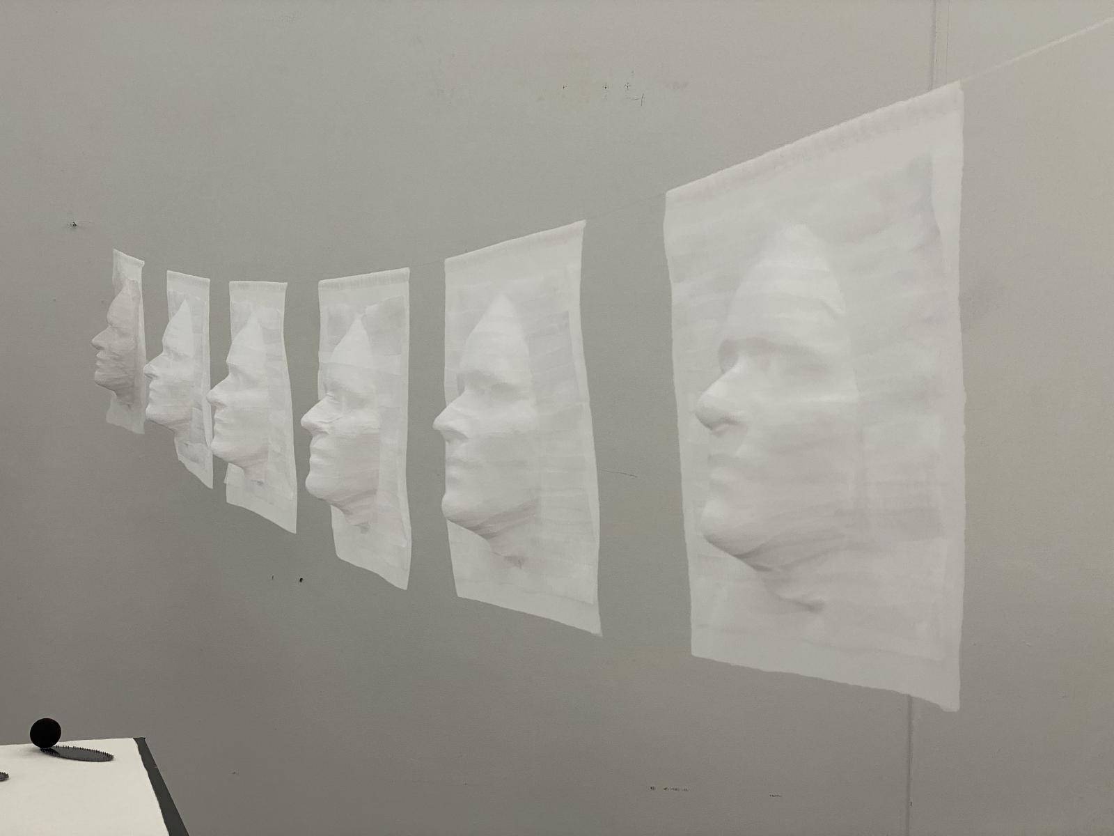 Life size self portraits strung on nylon cord. Made from strips of silk organza placed over 3D print, held together by rice glue. 