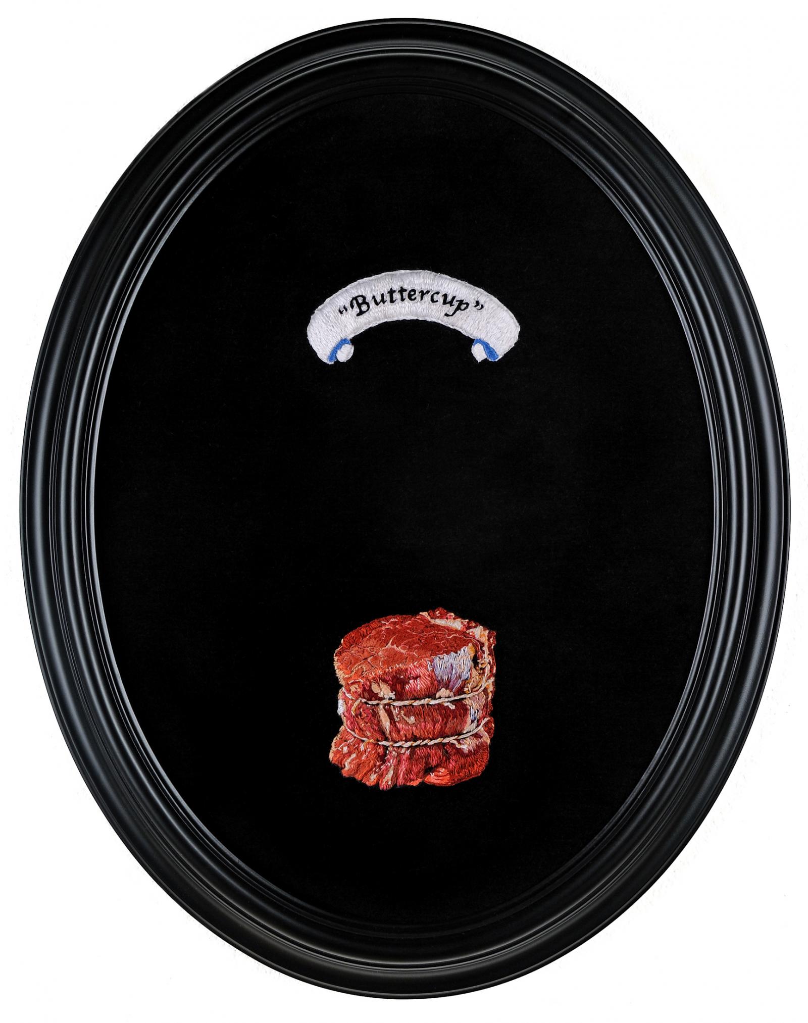 Embroidery depicting meat, and the name of a childhood corresponding animal.