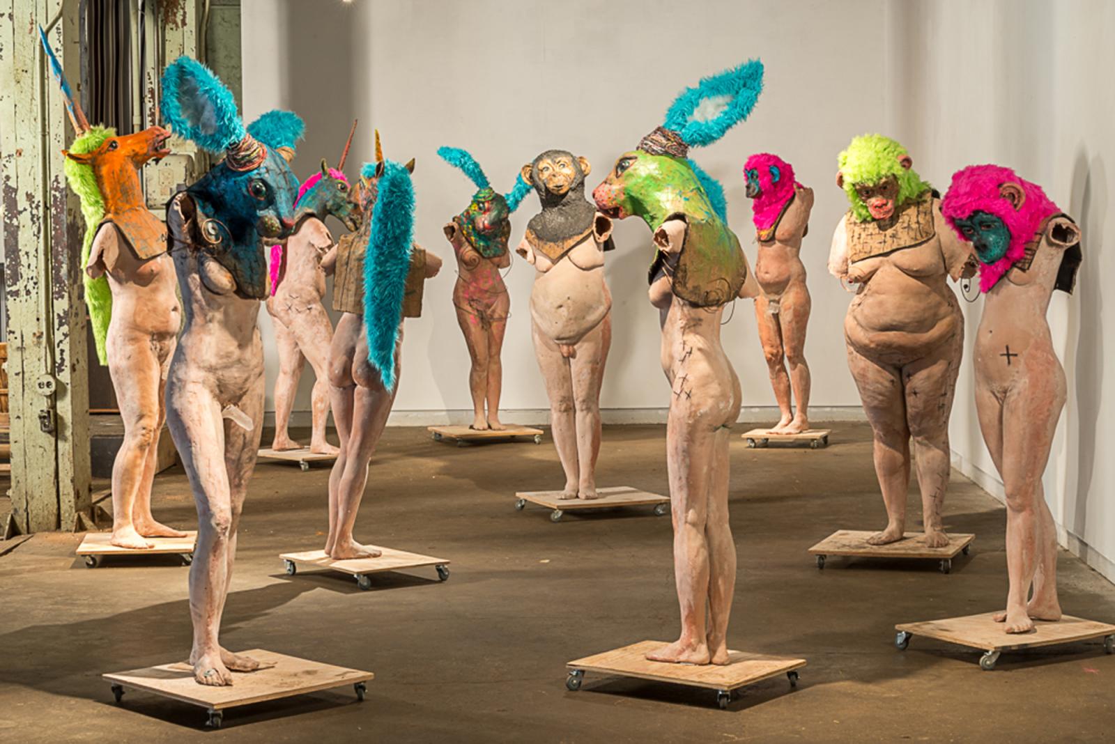 resin, fiberglass, mixed media, Dimensions variable,
	Animalia is an exploration of the fluidness of gender identity 	within our birth body I have been exploring gender fluidness in 	myself and in my community to try and open the dialogue of 	what gender means to me. I feel that we are all fluid in the fact 	the some times we may feel “masculine" while at another 	moment "feminine" and so how does this relate to gender. The 	fanciful animal heads allow me to present as a figure other than 	male or female.
