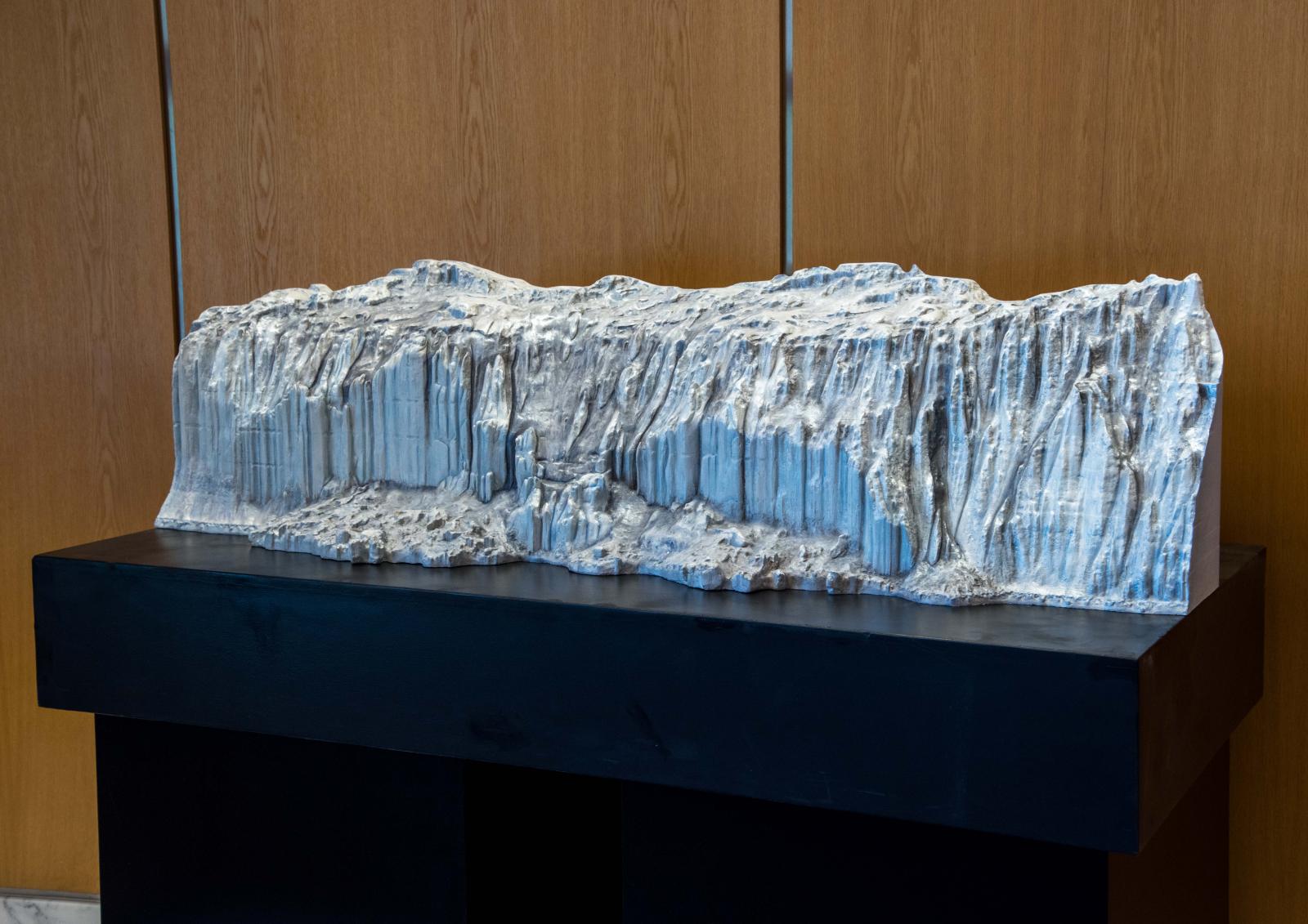 A section of the Canada Glacier in the McMurdo Dry Valleys made from 162 source photos taken on site fairly close to the face. The photos were processed into a 3D file, edited in 3D imaging software, and carved on a CNC (computer-controlled) router. I added additional hand carving and painted it.