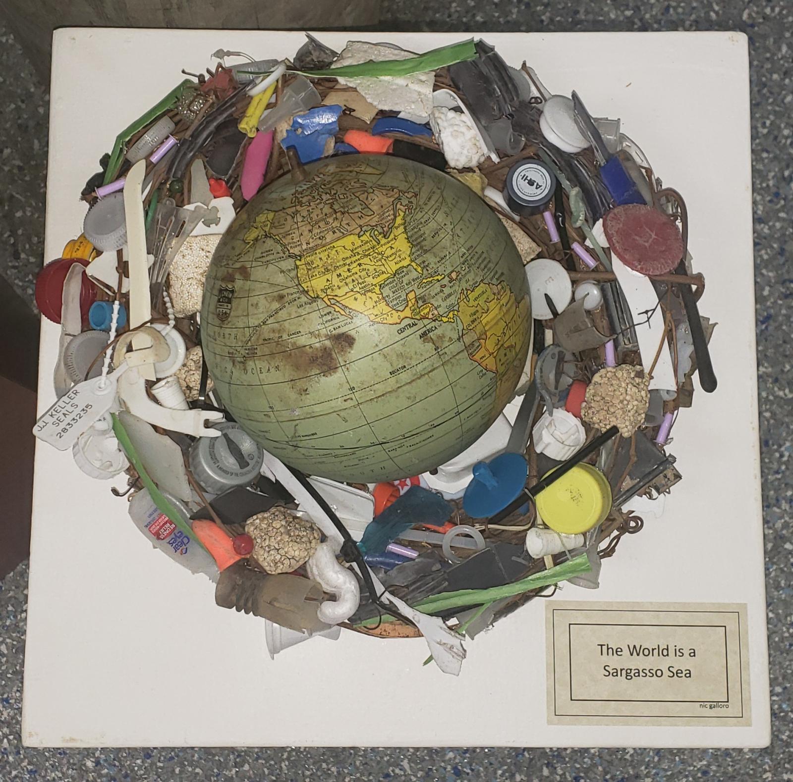 Found globe on vine wreathe with plastic waste.