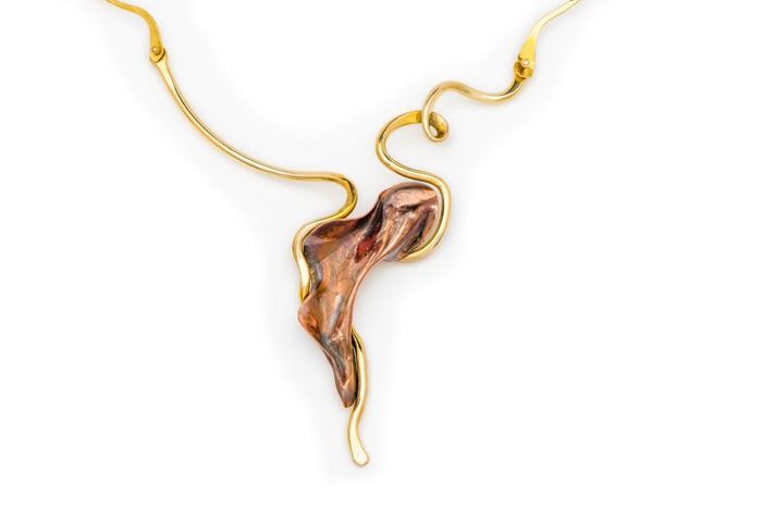 This is a large statement piece necklace made entirely through metal forming using copper sheet metal as well as swirling line work in bronze rod as well. The technique involves fusion welding by hand and metal forming using a wood block