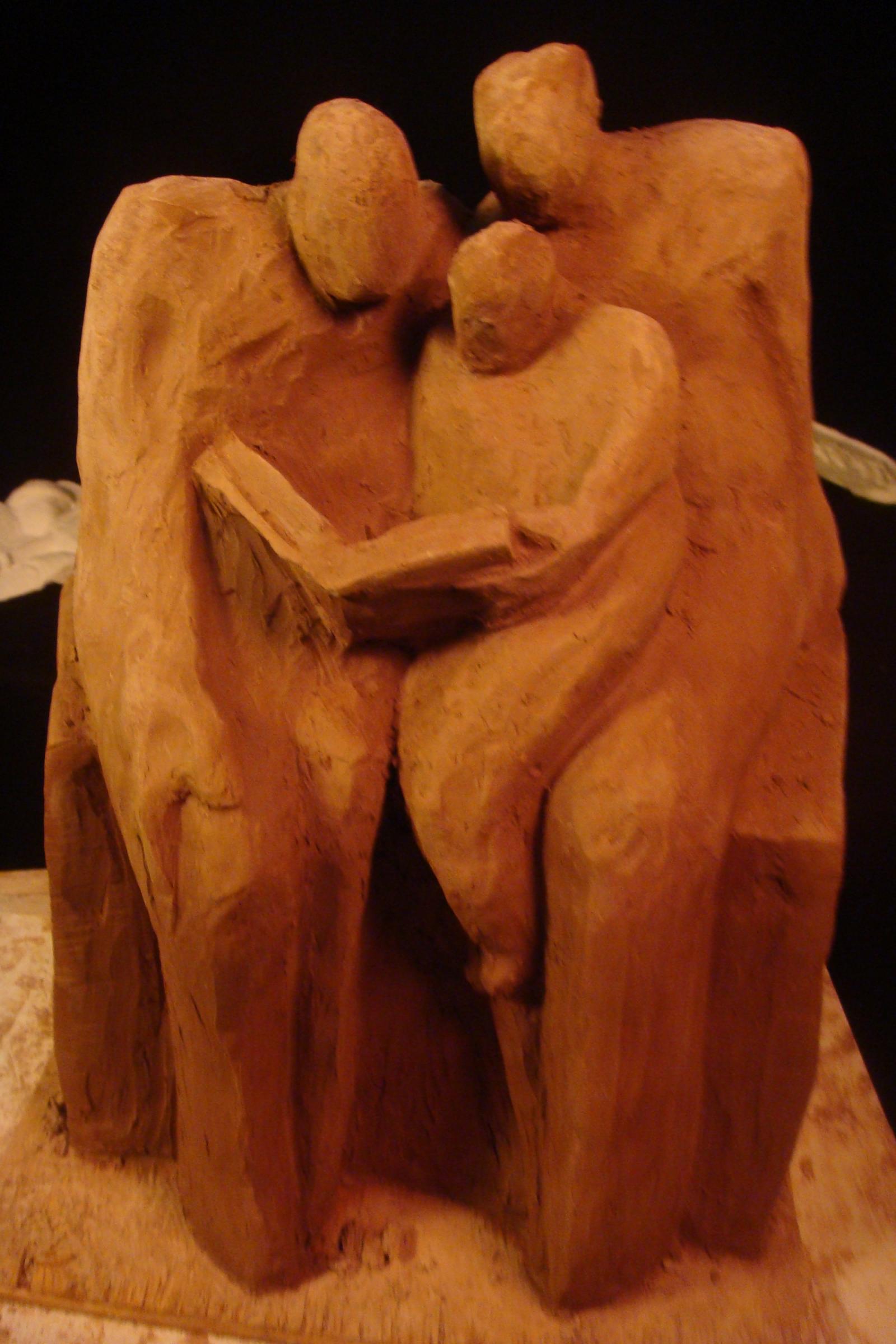 Sculpture of a family sharing a book
