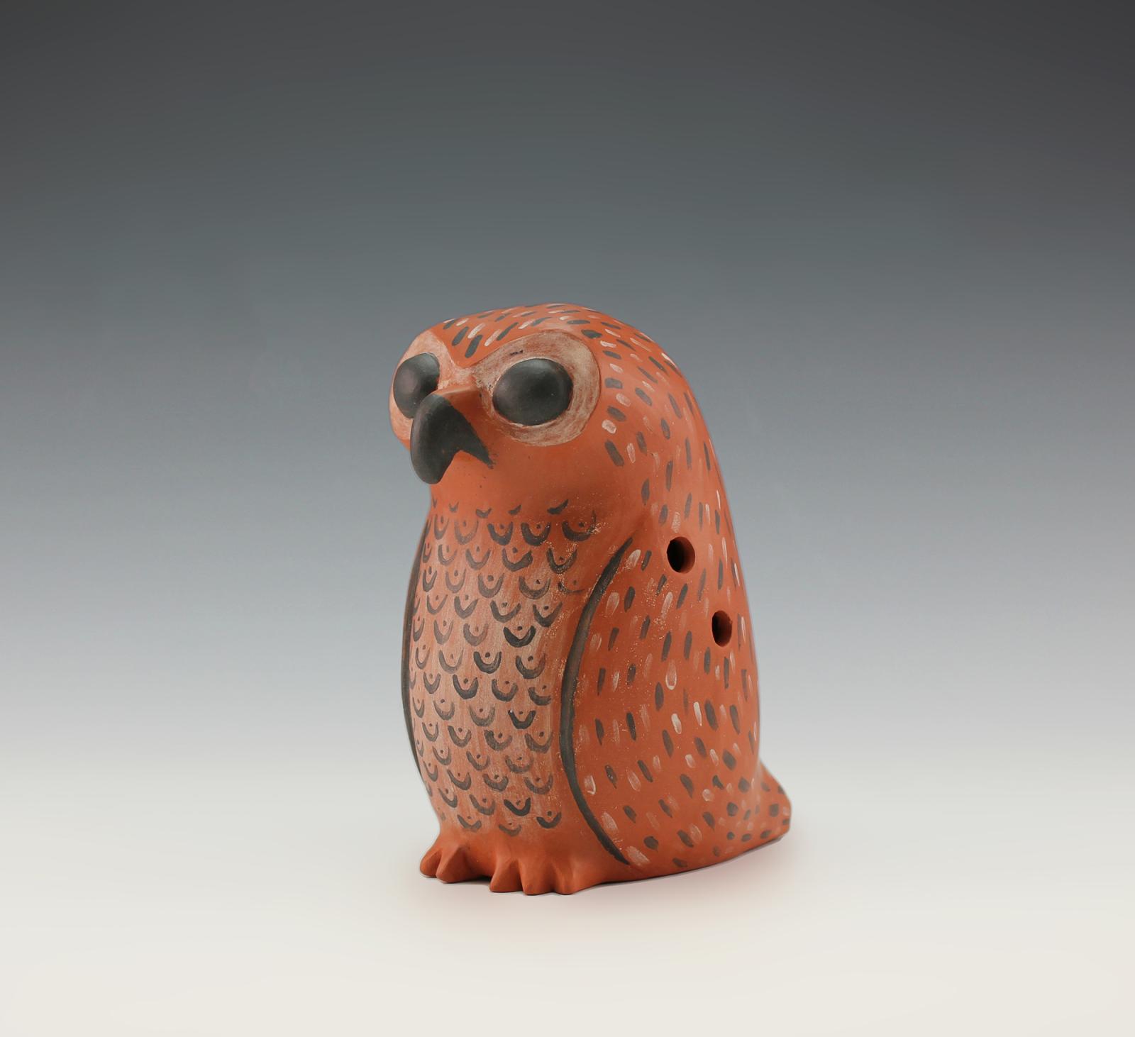 Globular or vessel style flute in the shape of an owl with painted iconography.