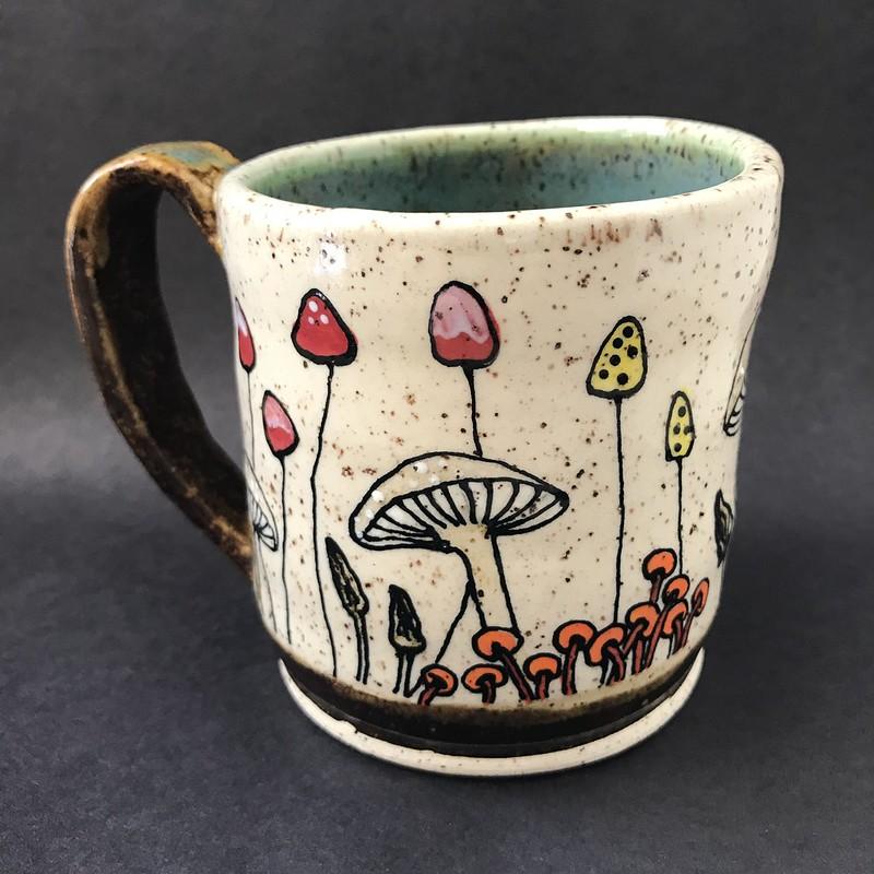 For the love of 'shrooms! Earthy goodness abounds on this substantial size mug that holds 12 ounces of your favorite coffee, tea or beverage of your choice! (This piece has been sold.)
All my mugs are hand-thrown by yours truly and are unique in their size, shape, and design... no two are ever exactly alike. I'm a small batch potter, designing and creating roughly 20 pieces at a time. Countless hours go into the creation of these mini-artworks... it is a true labor of love.