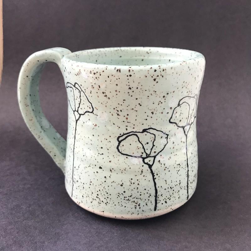 Simple, delicate blooms adorn this speckled turquoise mug that holds 10 - 12 ounces of your favorite coffee, tea, or... you decide! (This piece has been sold.)
All my mugs are hand-thrown by yours truly and are unique in their size, shape, and design... no two are ever exactly alike. I'm a small batch potter, designing and creating roughly 20 pieces at a time. Countless hours go into the creation of these mini-artworks... it is a true labor of love.