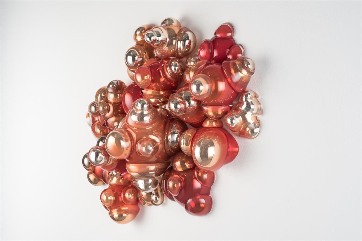 Red colored glass was blown, cut and then mirrored. Pieces were then fused together to form a composition on the wall.