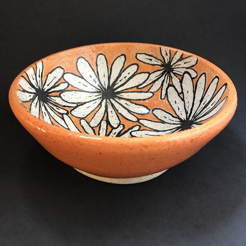 This one! You can't not be happy when you look down at this little bowl and see that pop of orange and all those daisies smiling up at you! This would make a fabulous little cereal bowl for exactly that reason... what a great way to start your day! Holds 2 cups (16 oz). (This piece has been sold.)
All my creations are hand-thrown by yours truly and are unique in their size, shape, and design... no two are ever exactly alike. I'm a small batch potter, designing and creating roughly 20 pieces at a time. Countless hours go into the making of these mini-artworks... it is a true labor of love.
