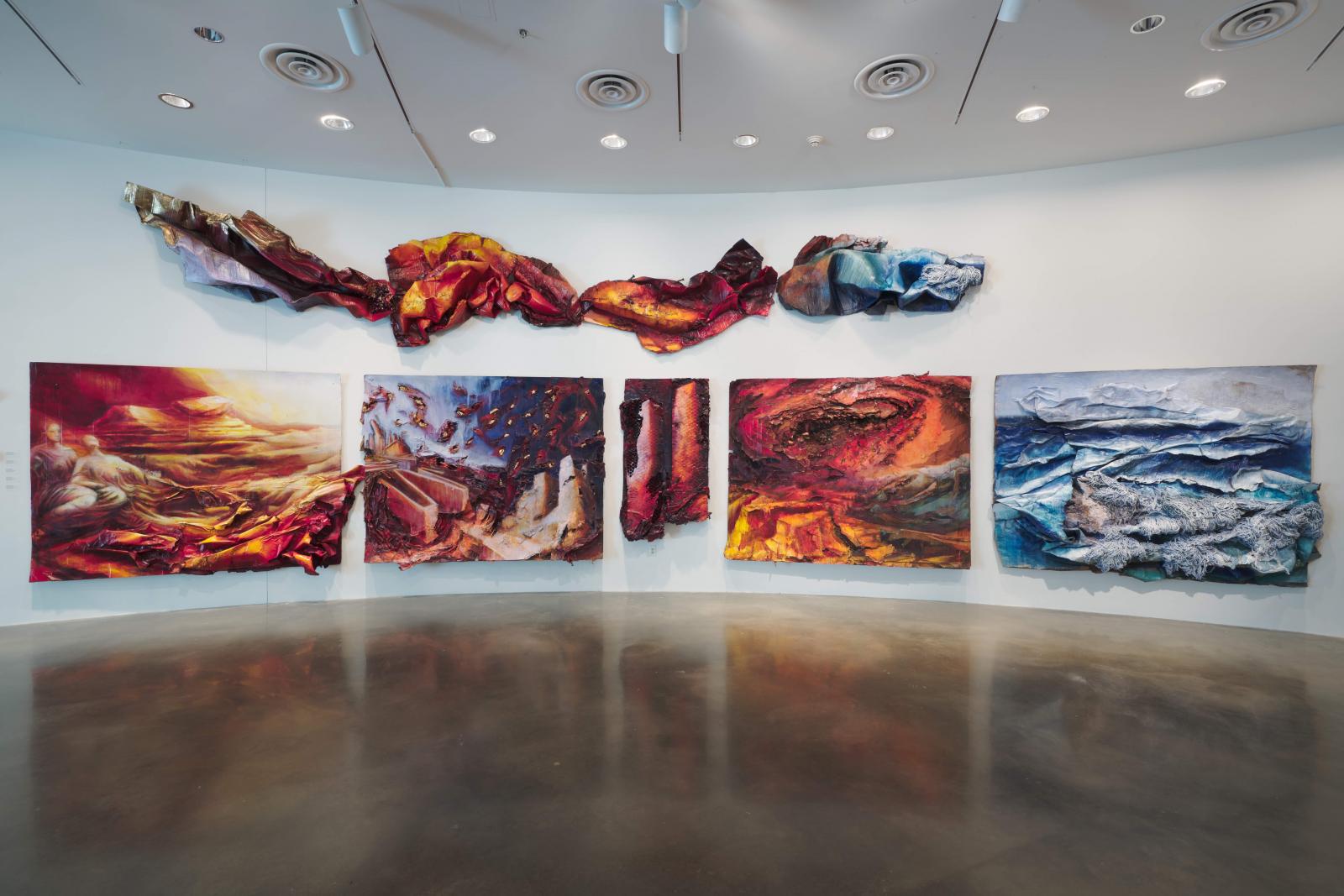 Wall Works Installation of "Gaia Rise" Cycle 2019-2020
American University Museum at the Katzen Arts Center
I propose polit-myth as an artistic strategy to seek a paradigm shift towards political decisions that are motivated by environmental concerns of climate change caused by human activity rooted in myths and histories. 
I process corrugated cardboard, the ubiquitous signature for our globalized consumerism, into multilayered paintings. Through principles of disappearance, disintegration, and abrasive operations, painterly actions of spilling, mopping, and raking, I share underlying tales and myth expressing environmental concerns engraved into the Anthropocene as a geological force transforming the planet. 
