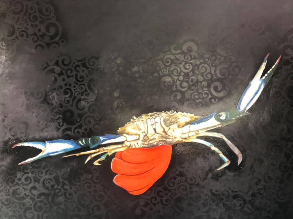 Orange glove holding crab