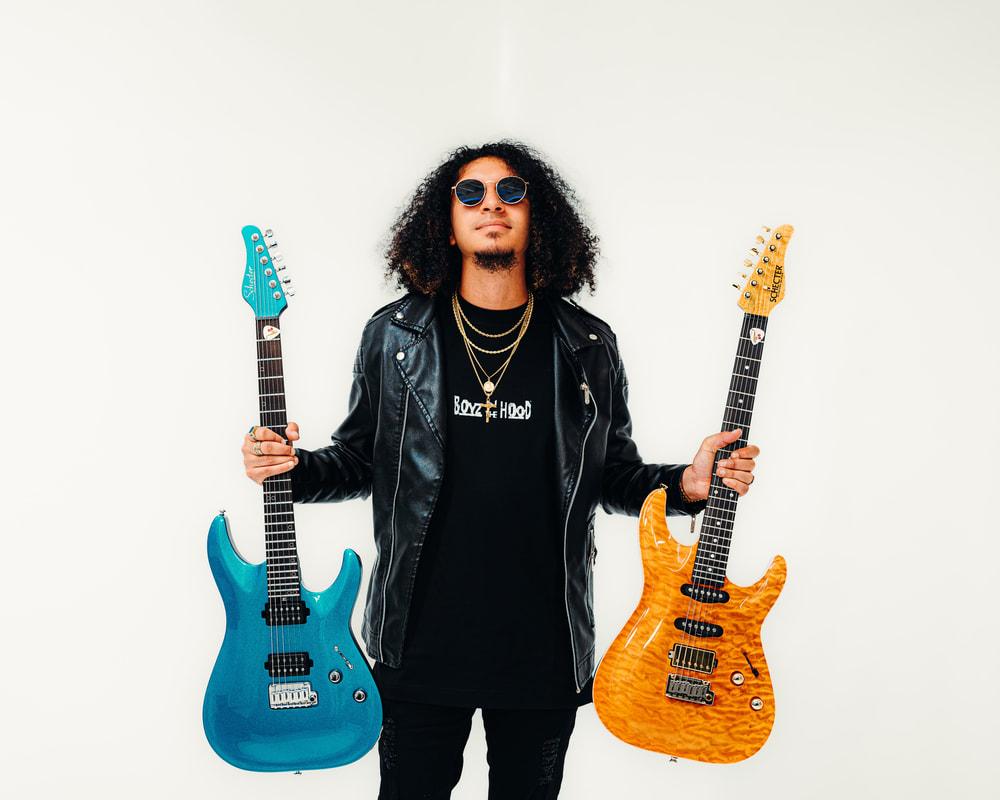 Saxl Rose pictured with his two signature Schecter guitars, proudly representing his official brand partnership with Schecter Guitars.
This collaboration reflects Saxl Rose’s versatility as a multi-instrumentalist and his alignment with leading innovators in the music industry