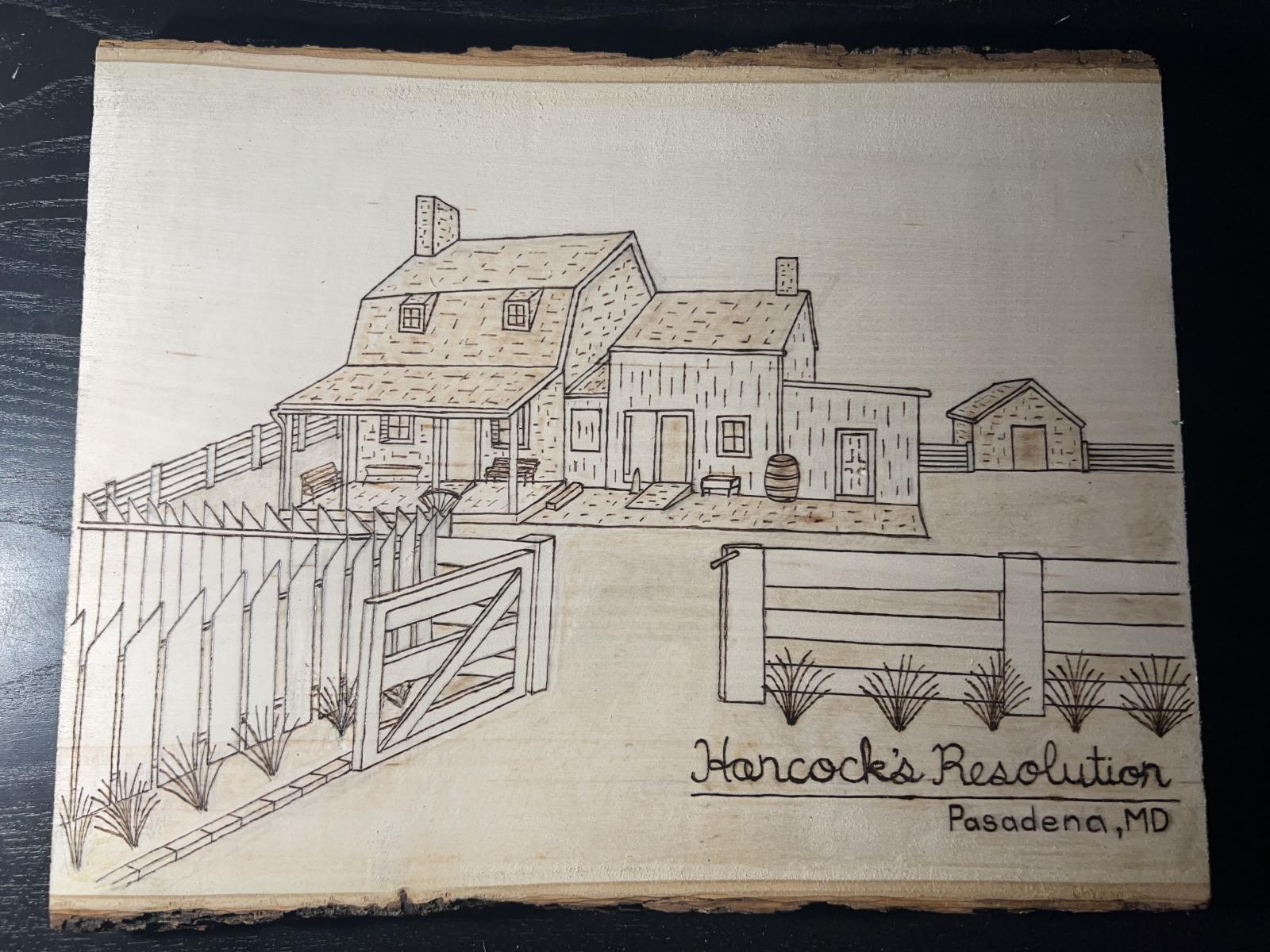 This piece of live-edge basswood features a hand burned image of Hancock’s Resolution down near the mouth of the Patapsco River at Bodkin Creek.