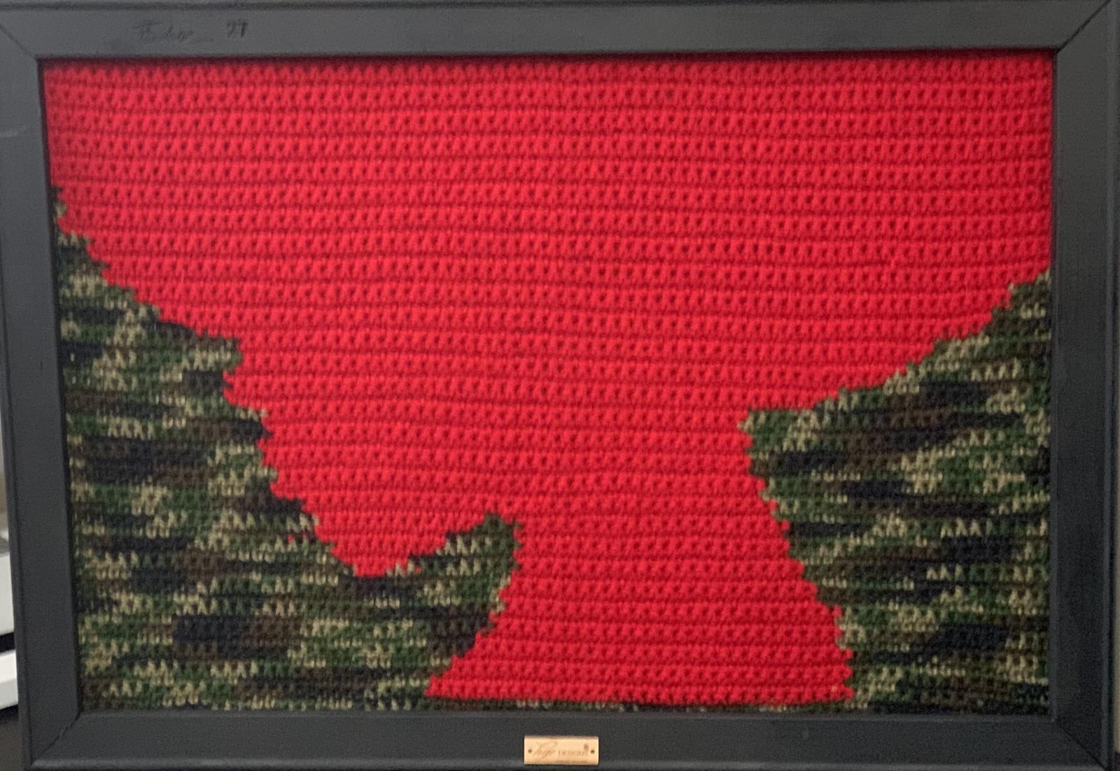 Hand crocheted portrait of a silhouette of a Black woman's hair. This piece was created of acrylic fibers.