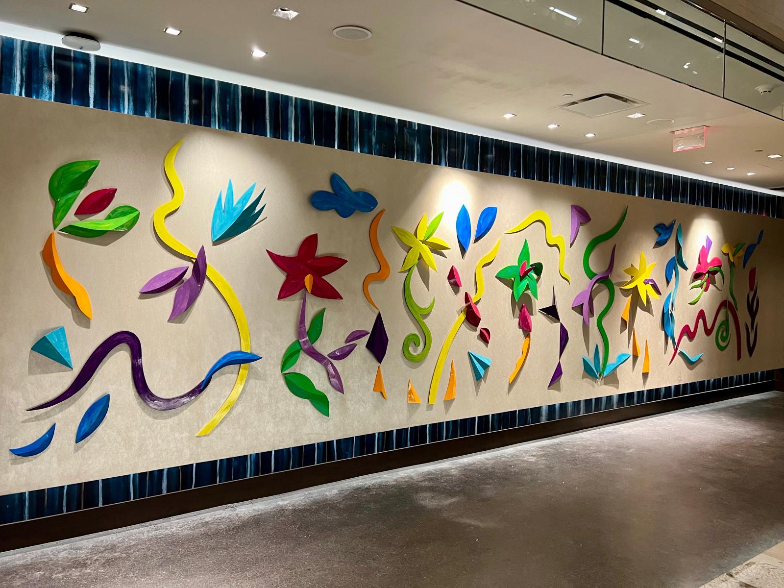 Inspired by flora and fauna of a verdant tropical environment both on land and in the water, AquaFauna, creates an immersive environment through wall mounted organic forms. The surfaces are painted with a base coat over which freely brushed textures and lines add depth and complexity.
