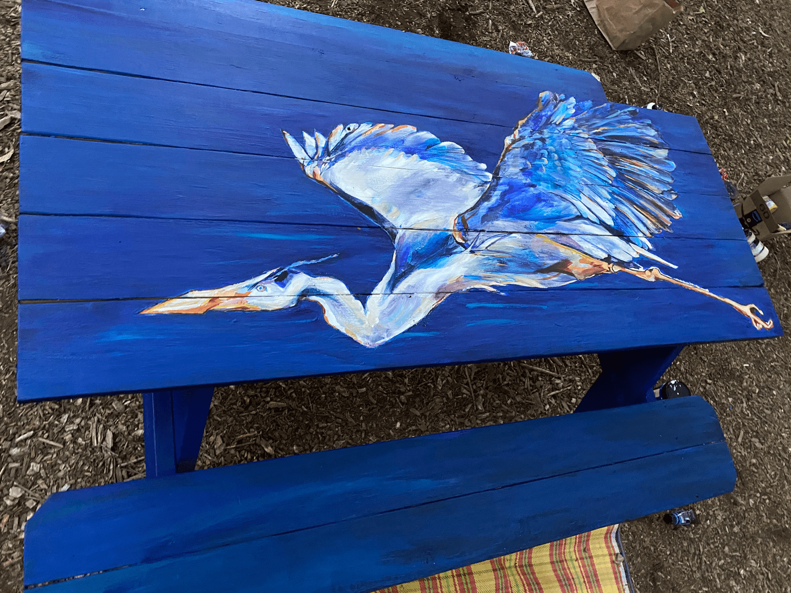 A painted picnic table for the Merriweather Post Pavilion. Painted with acrylic paint, the heron was chosen as a symbol of the unique avian life found in the Chesapeake's ecosystem.