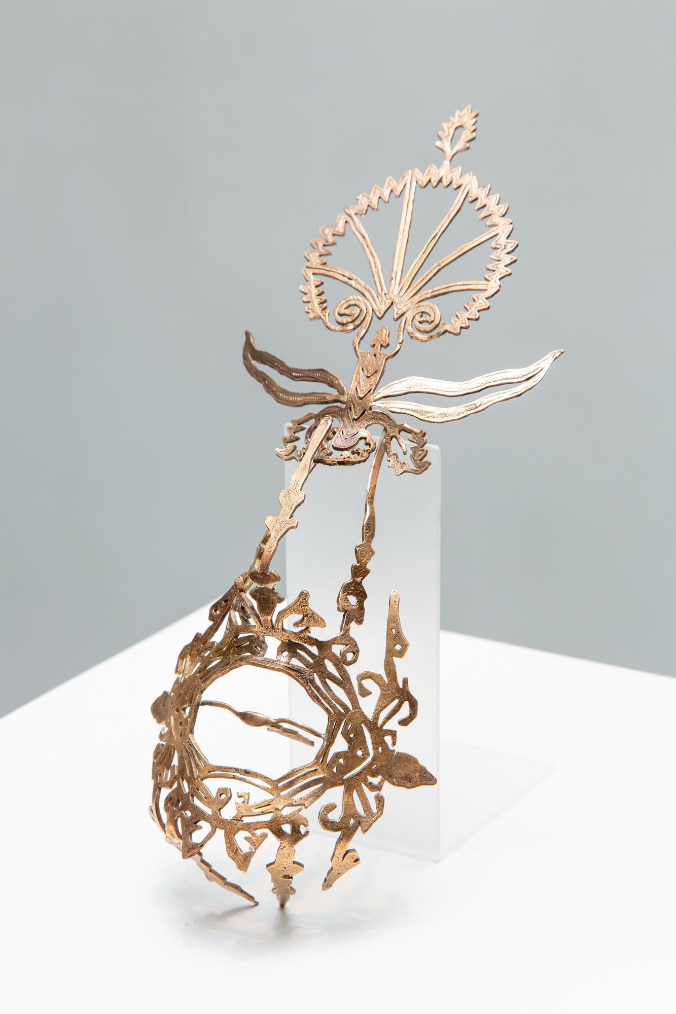 Artist Sera Boeno culminates six years of artistic exploration about gender-related power struggles in “Kelimeler Kıyafetsiz (:Words Naked/Are Not Enough)”. Using her native Turkey as inspiration, the focal point of Boeno’s exhibition is a sculptural installation adapted from the altar of Pergamon, a masterpiece of Hellenistic architecture excavated from Bergama in the Ottoman Empire (Izmir in current day Turkey) and currently held by the Pergamon Museum in Berlin, Germany. Emblazoned with quotes from Turkish media about women, Boeno’s monument serves as a stage for female performers wearing bronze ornaments of domination and torture that are embellished with delicate patterning found in Turkish illuminated manuscripts and textiles. By casting her performers as literal “pillars” of a monument dedicated to female subjugation, Boeno considers the myriad ways in which power dynamics are made manifest, whether through the essentialization of the East by the global West, or through the silencing and omission of women from representation; a story that is neither new, nor one that is exclusive to Turkey.