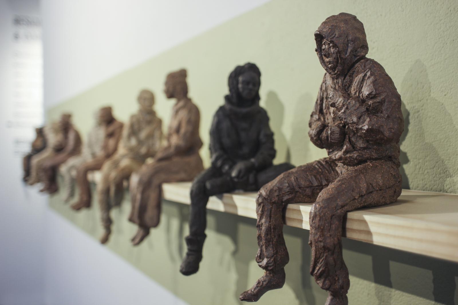 Ceramic wall installation during Weaving Visions, the annual resident show at Creative Alliance. Bus Stop includes 12 8-10" ceramic figures.