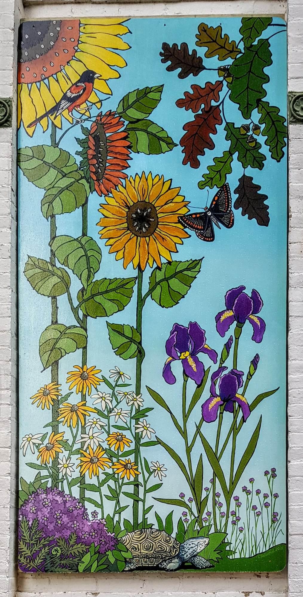 This outdoor mural depicts a garden scene highlighting Maryland. The checkerspot butterfly, Baltimore oriole, diamondback terrapin, white oak, and black-eyed susans are all Maryland state items. The other plants and flowers are found in the garden behind the building where the piece is permanently installed, the Cecil County Arts Council building in downtown Eklton, for public display.