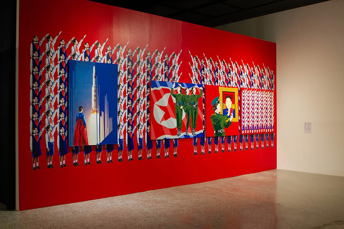 During the Busan Biennale 2018, Cheon’s work was installed in Museum of Contemporary Art (MoCA) Busan in S.Korea. Here, the installation highlights a series of paintings and prints as echoing the aesthetics of North Korean Mass Games, with the art Happy North Korean Children photographic vinyl wall as a backdrop. 