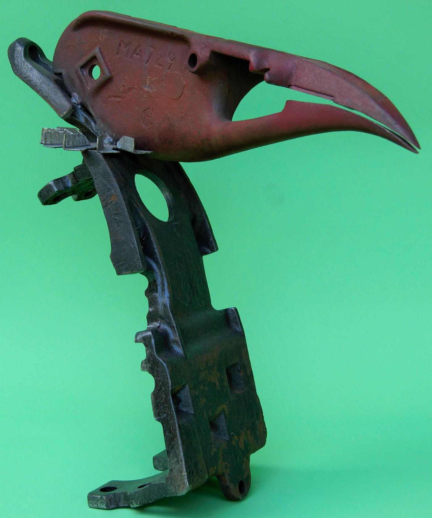 A work depicting a carrion eater. Made in the round and comprised of machine parts.