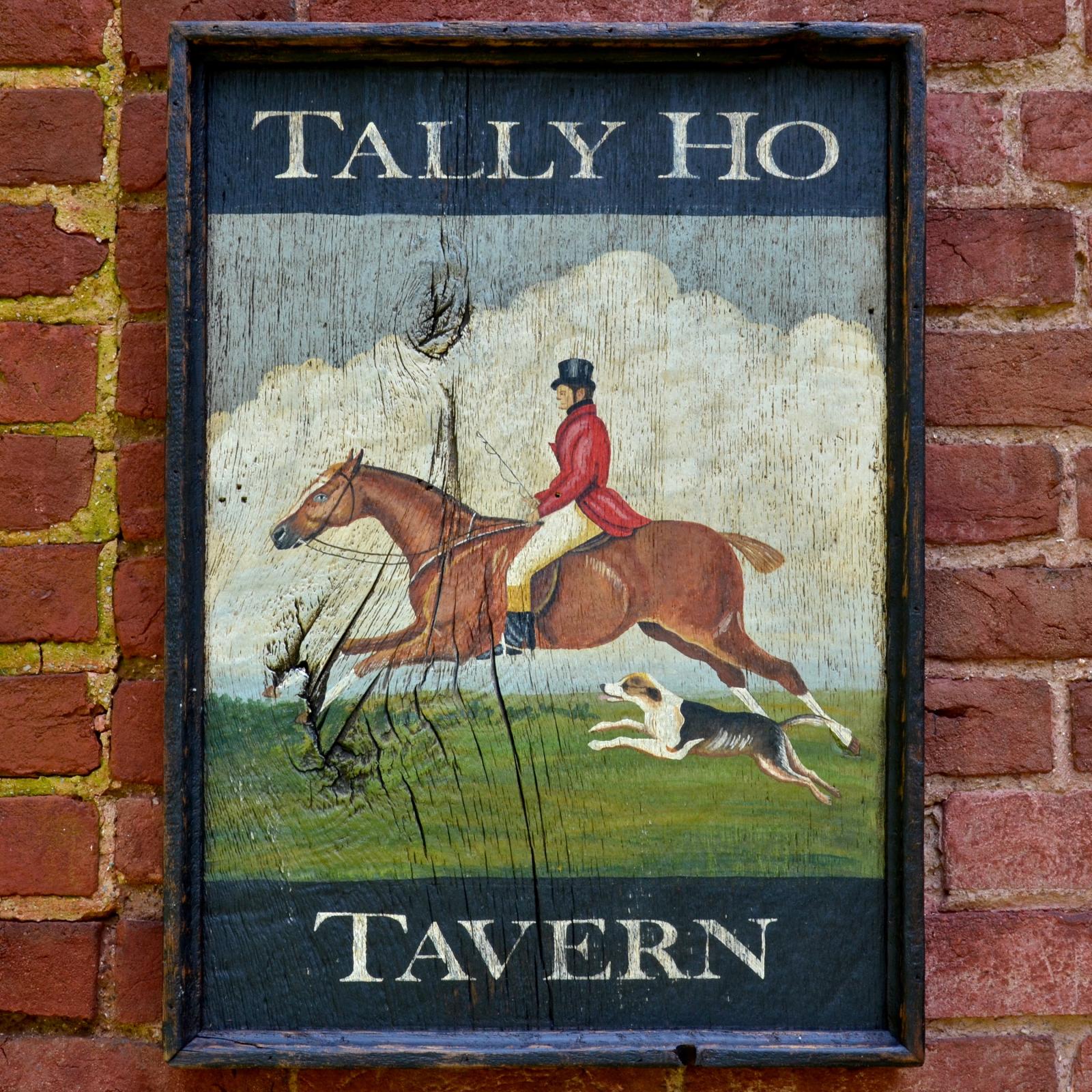 The Tally Ho Tavern sign is created to look like an antique sign and is painted in a primitive manner as would have been done in the mid 1800s.