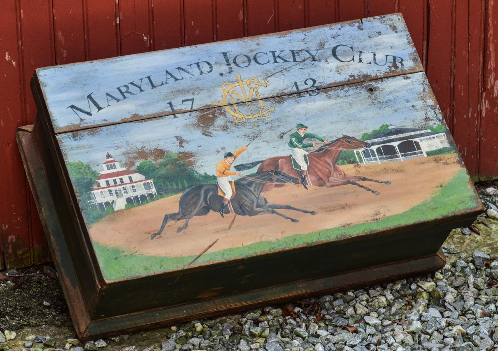 An antique box painted for a client who breeds racing horses in Kentucky. The breeder used to be in Maryland and wanted to include references to the Pimlico and Laurel race tracks.