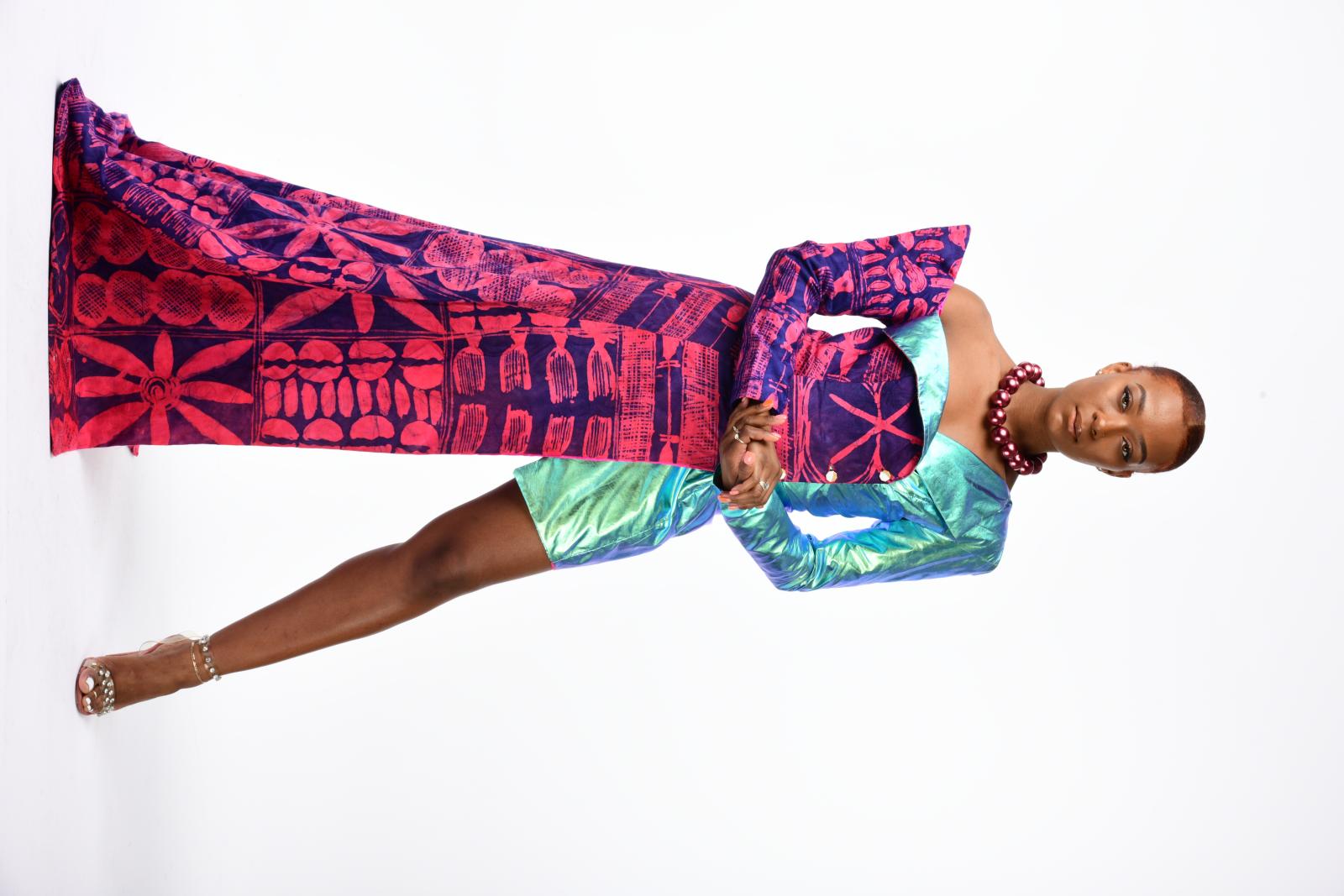 The Irawo Dress, which means "star" or "shine" in Yoruba, is a stunning example of the fusion of traditional African fabrics with iridescent futuristic materials. This piece is part of my Femme Futuris collection, which celebrates the power of women in shaping the future. The Adire fabric used in this dress carries deep symbolism, representing the beauty and strength of women as pillars of their communities. The intricate designs, featuring Yoruba symbols such as flowers, cowries, pillars, and hair combs, highlight the enduring beauty and resilience of women, who continue to shine bright even when their contributions are overlooked. The Irawo Dress is a testament to the power and beauty of women and a celebration of their important role in shaping our world.