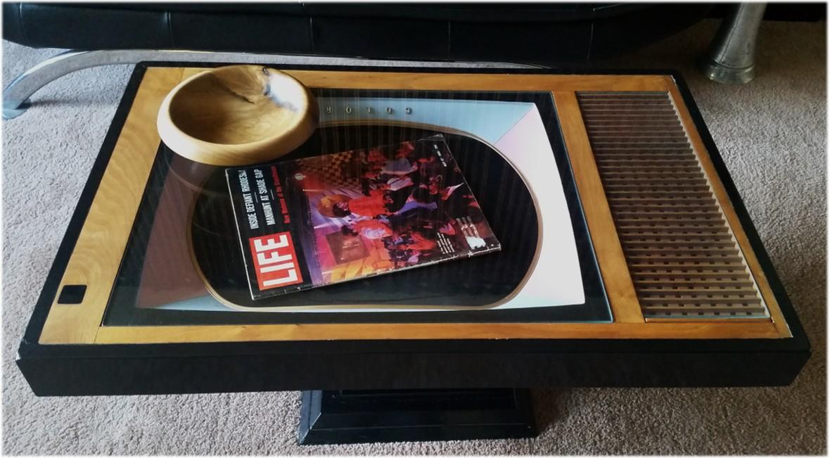 Salvaged front of a discarded Mid-Century TV given a new life - set on a wood plinth and within a lacquered frame