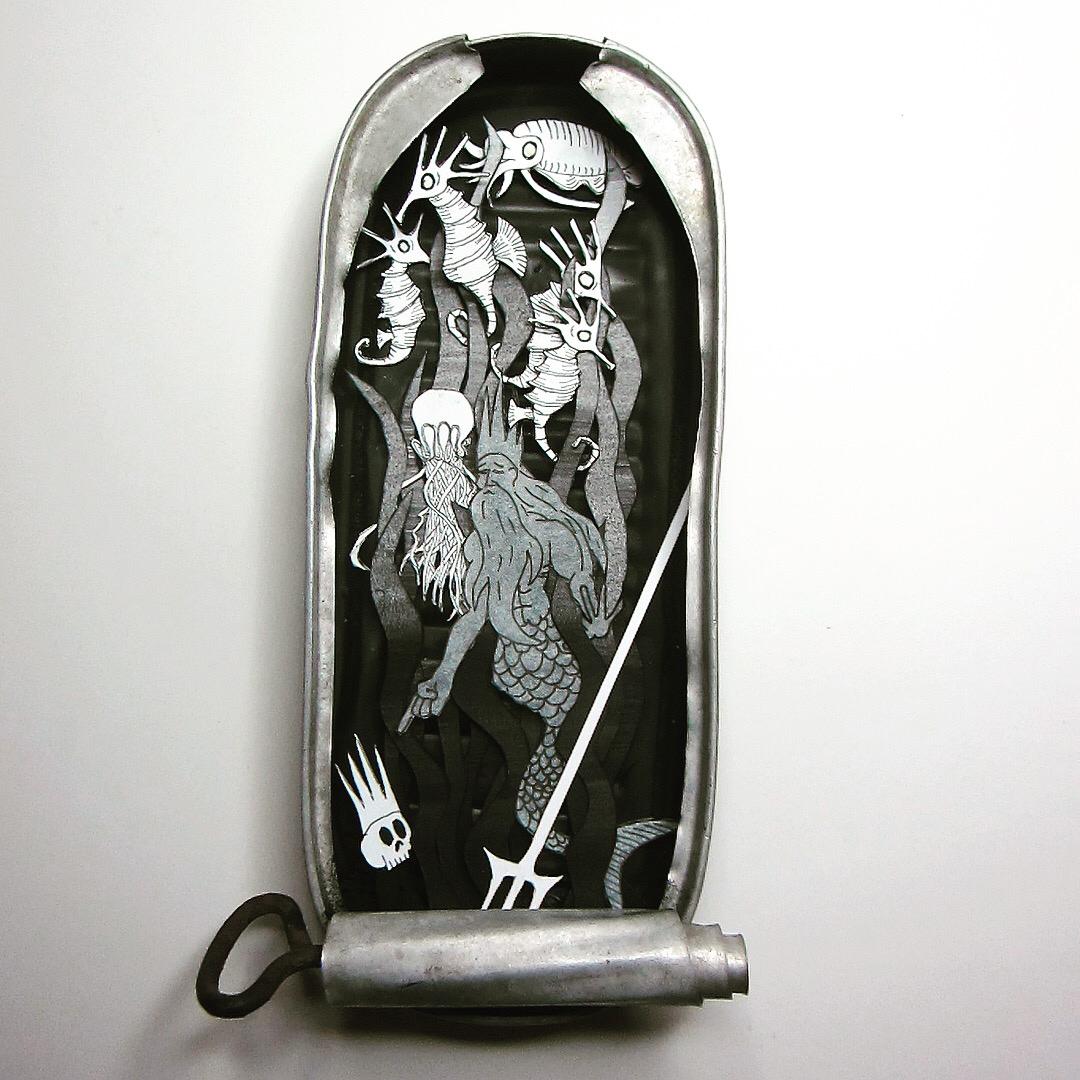 Cut paper diorama showing the ghost of Triton in his final resting place.
